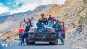 3Young Girls and 4Young Boys Take A Photo on the red scarpio Car with Tour