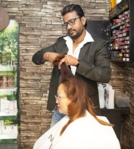 A man cutting female hair image